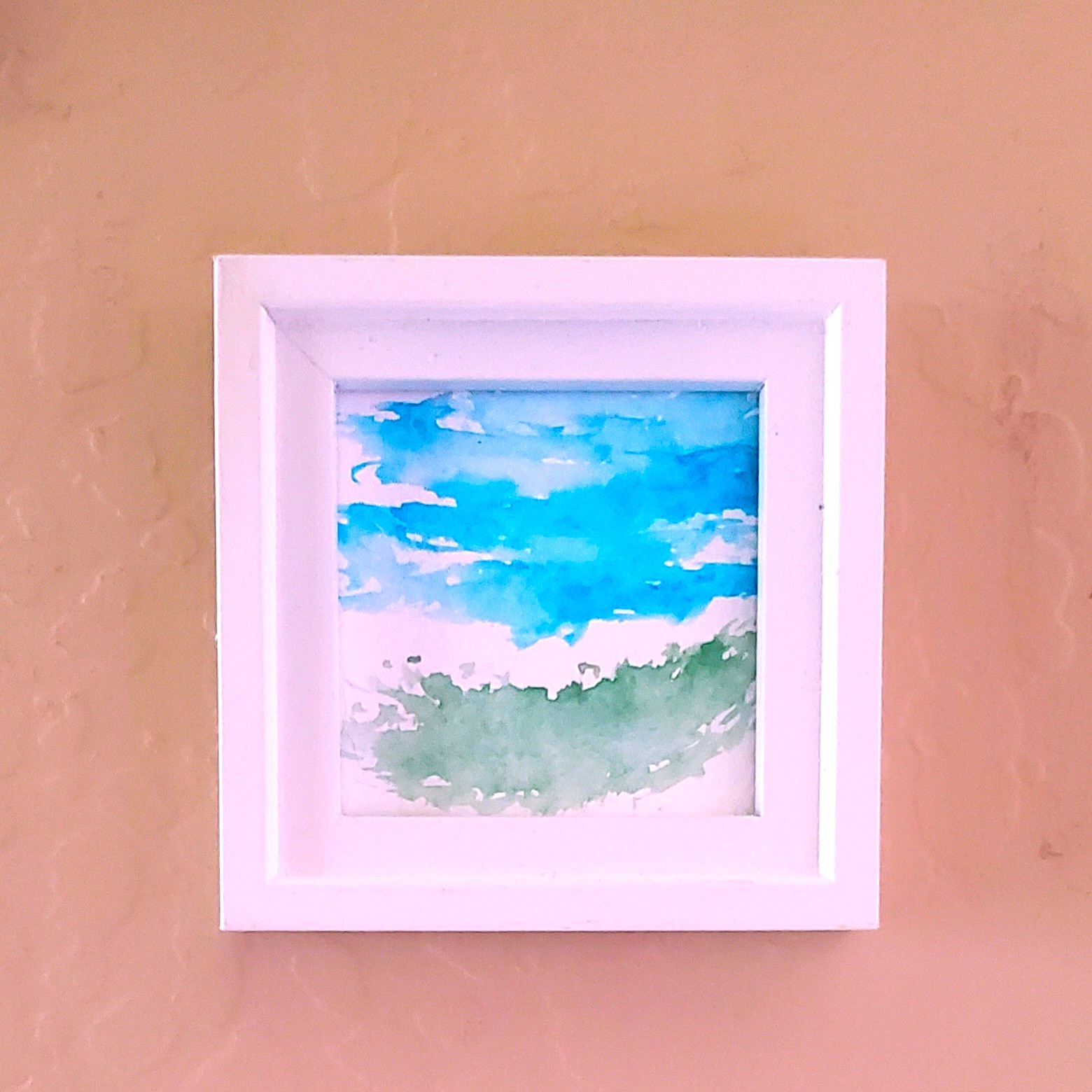 Summer Skies is a small watercolor study measuring 3 by 3 inches, framed simply...