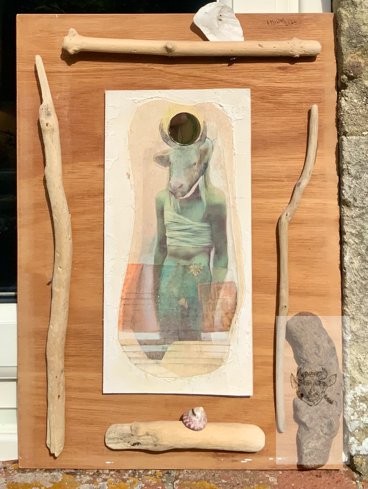 The painting has driftwood and shells around it